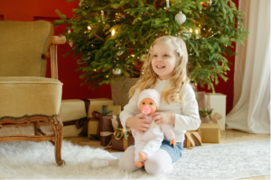 child by christmas tree