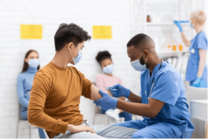 A nurse administers an injection. He may be conducting clinical research.