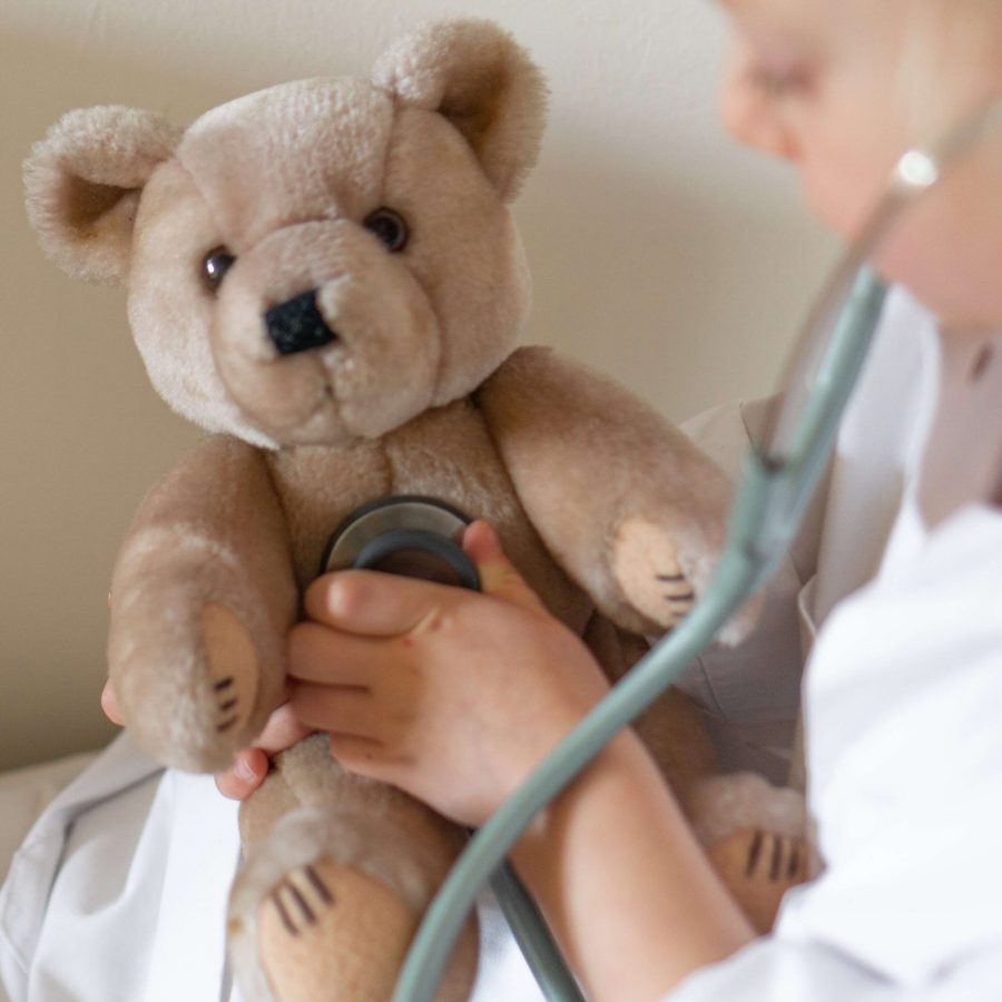 teddy bear and child with stethoscope